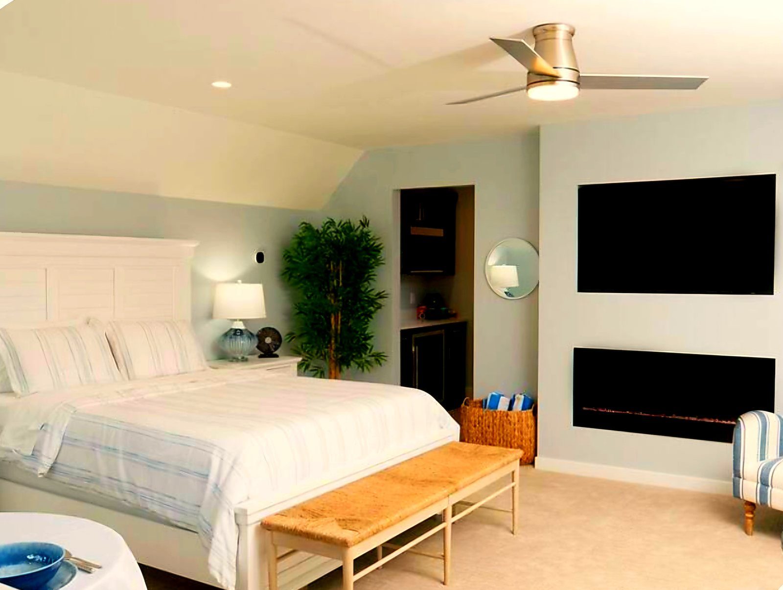King Suite bedroom with king bed, fireplace, and wall-mounted TV